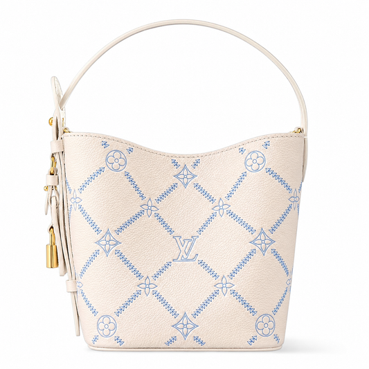 Beige handbag with blue embroidery on a white background
